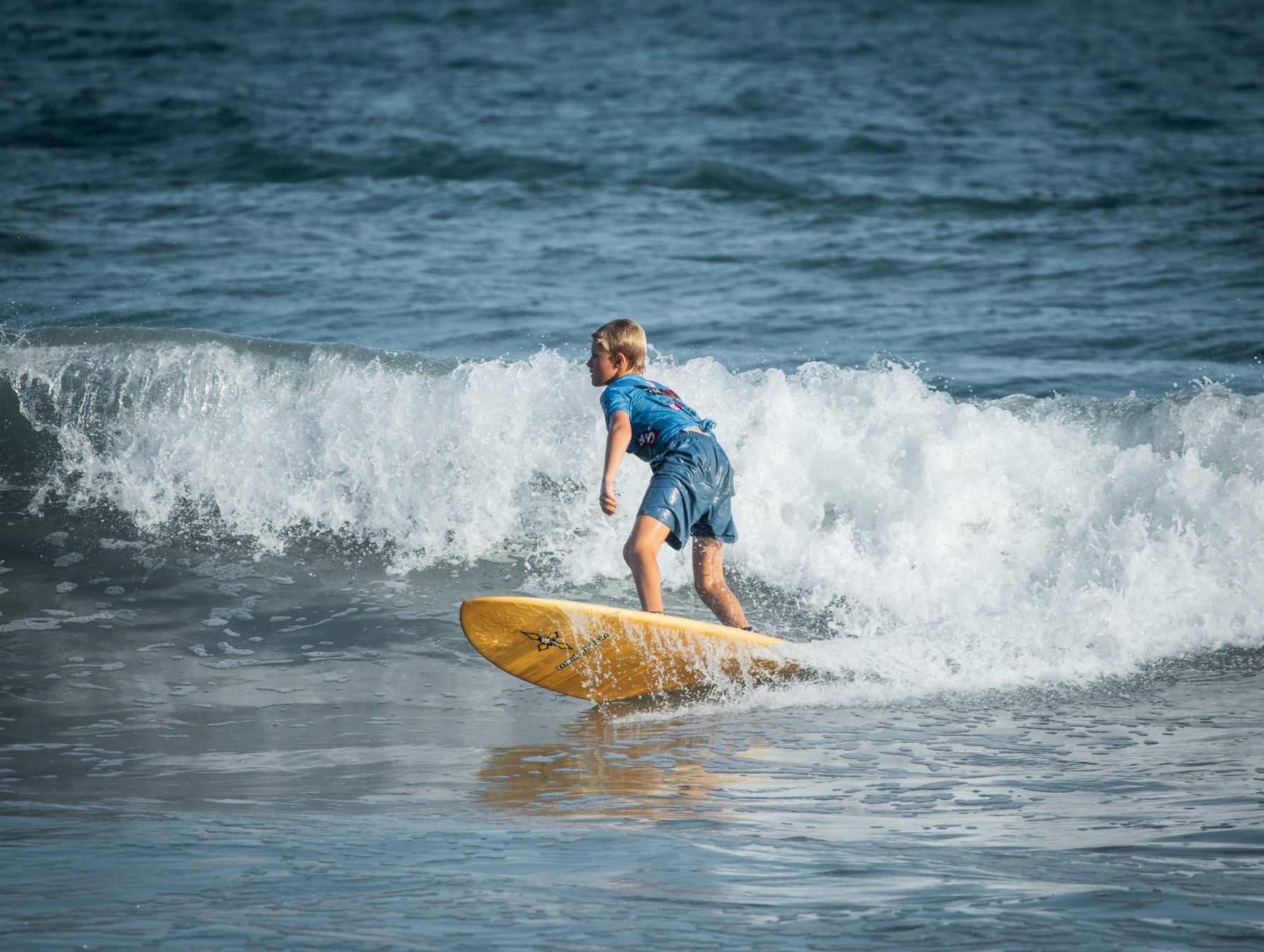 Young surfer riding a wave at Playa Sámara